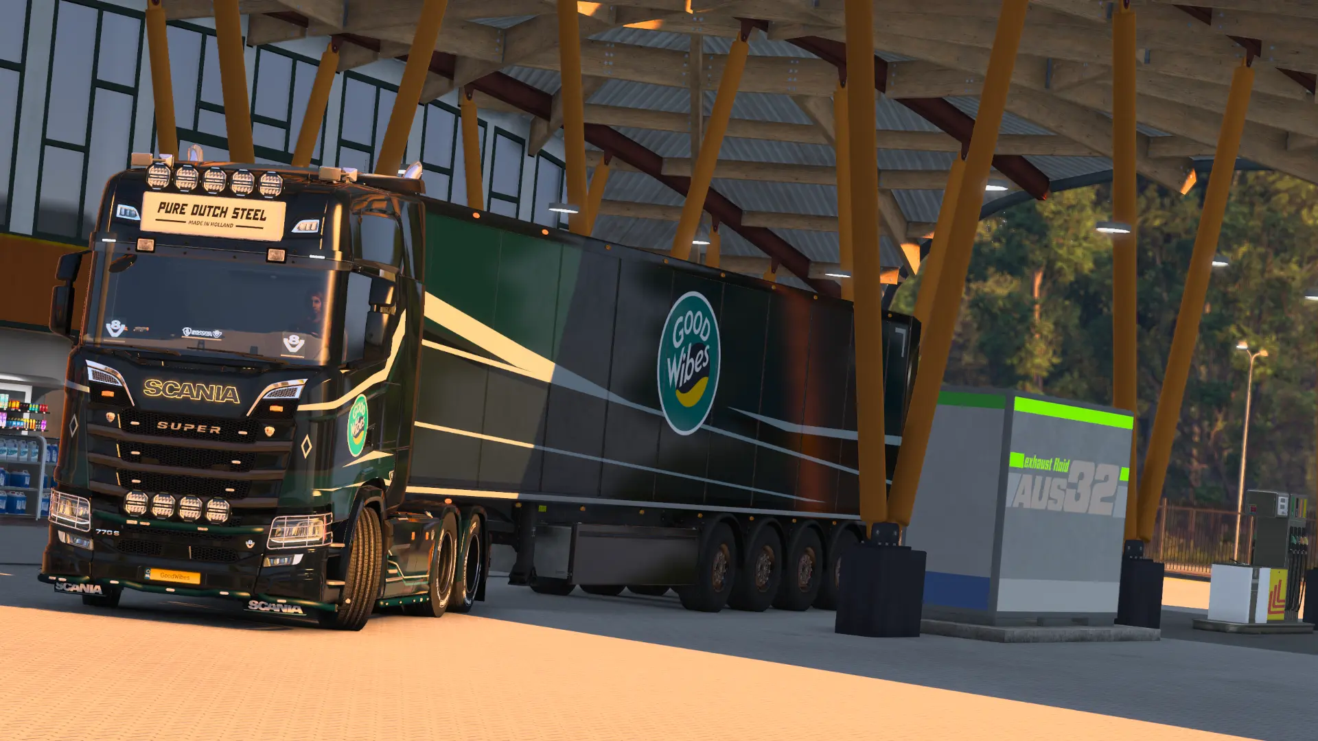 GoodWibes truck parked at a fuel station at sunset